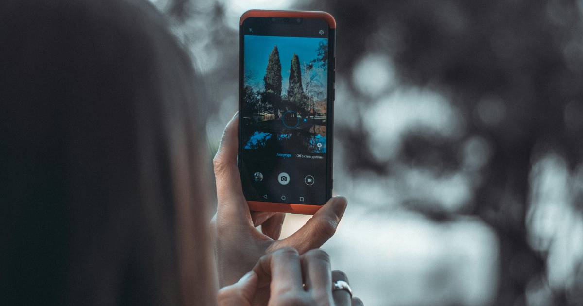 Person taking photo on smart phone.