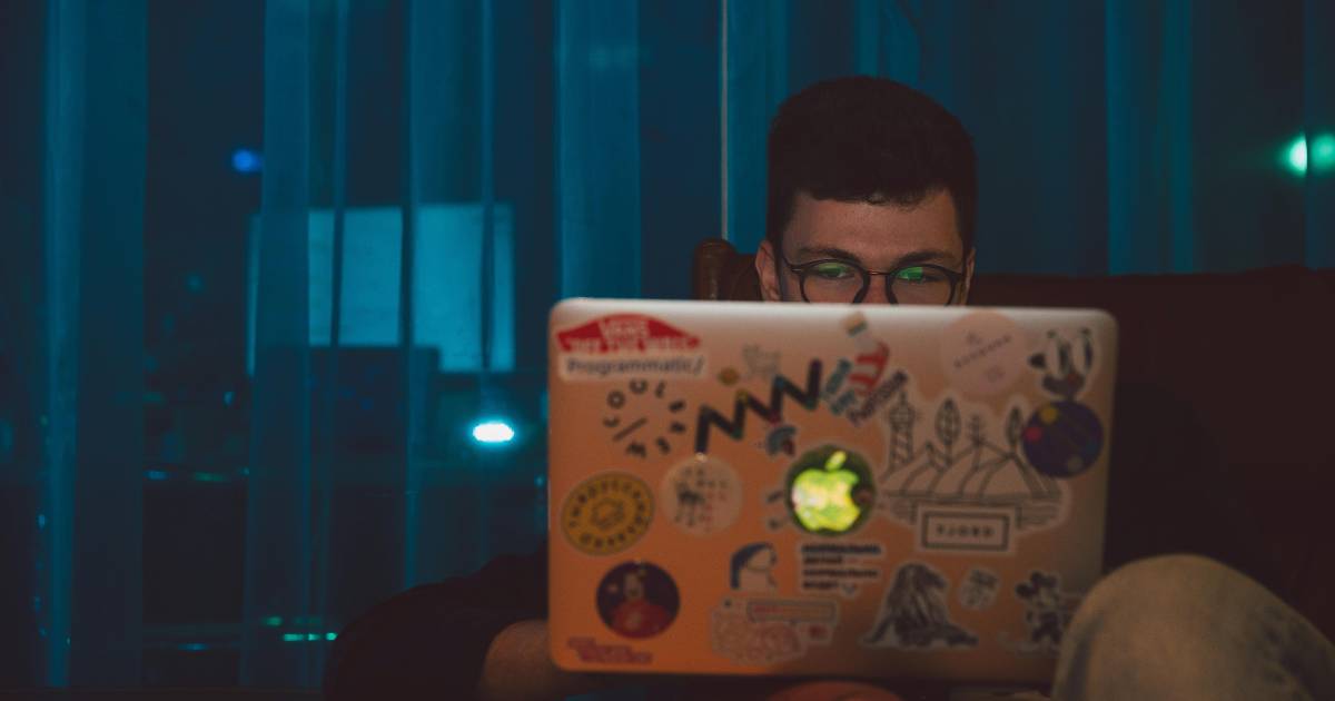 Man at laptop researching.