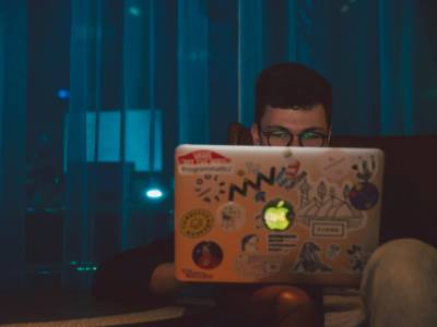 Man at laptop researching.