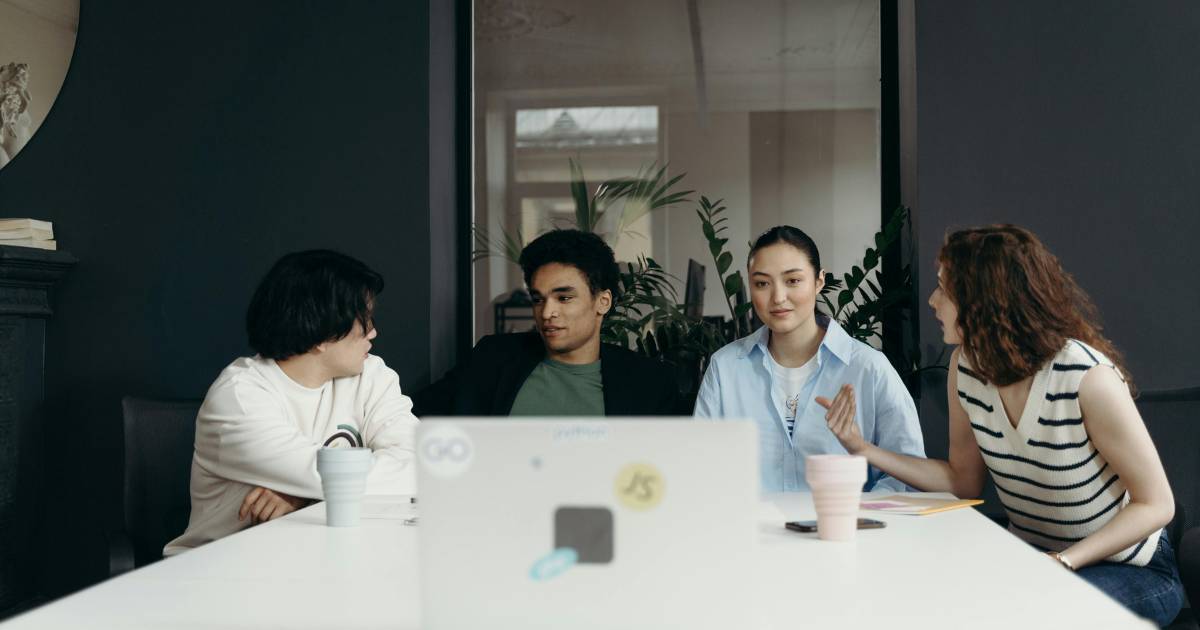 Group of people having a discussion at a table.