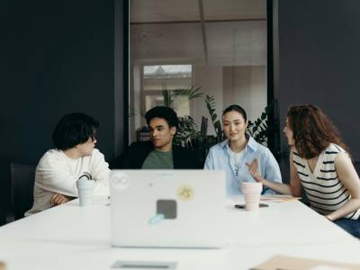Group of people having a discussion at a table.