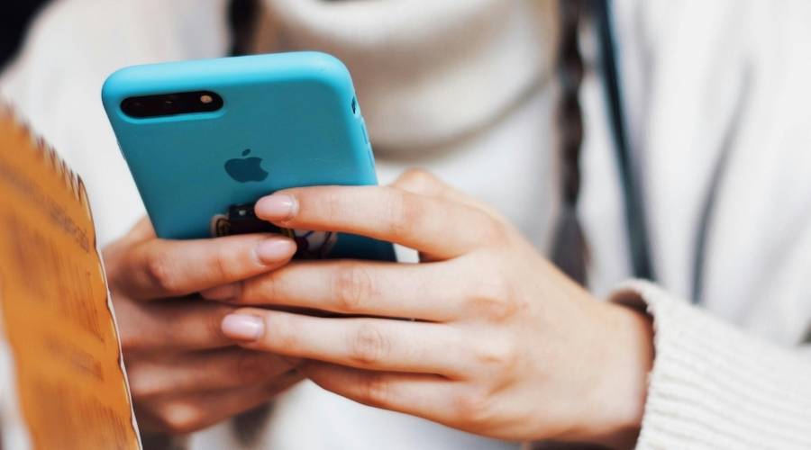 Close up of hands using smartphone.