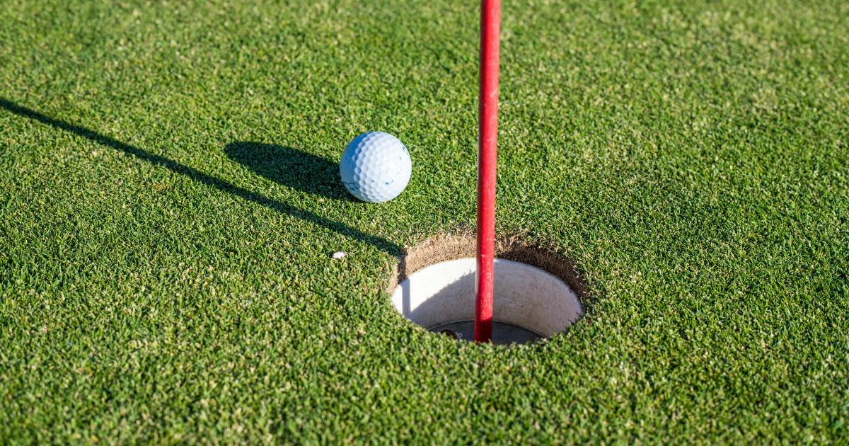 Close-Up Photo of a Golf Ball Near a Hole