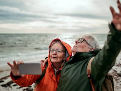 two friends taking photo at the beach.
