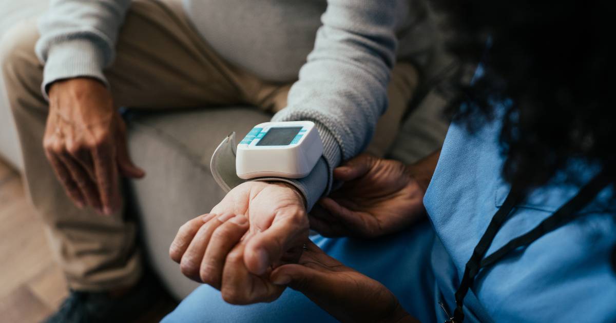 Home medical consultation, elderly person measuring blood pressure