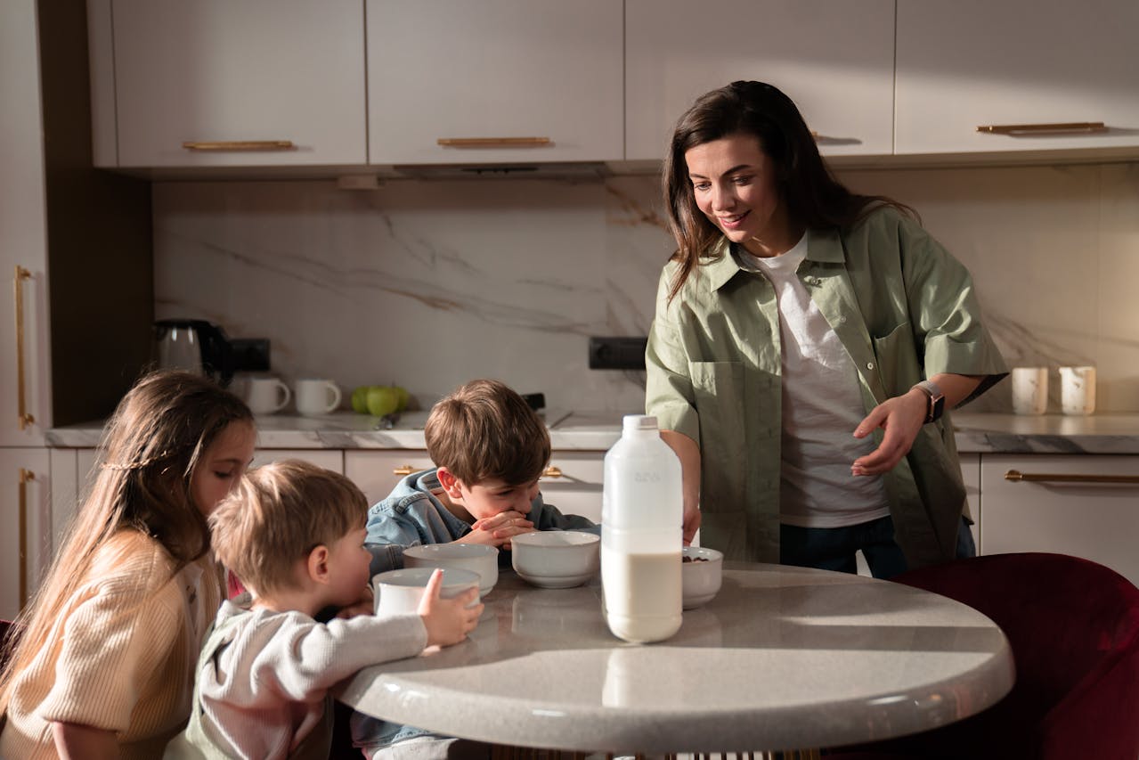 mother and children having breakfast at home.