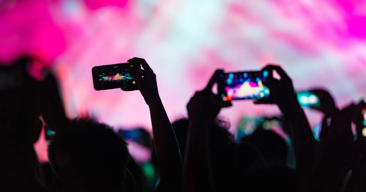 Phones taking videos at concert.