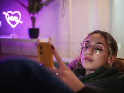 Young girl at home using smartphone