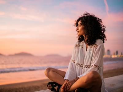 Young woman looking at view contemplating on the beach.