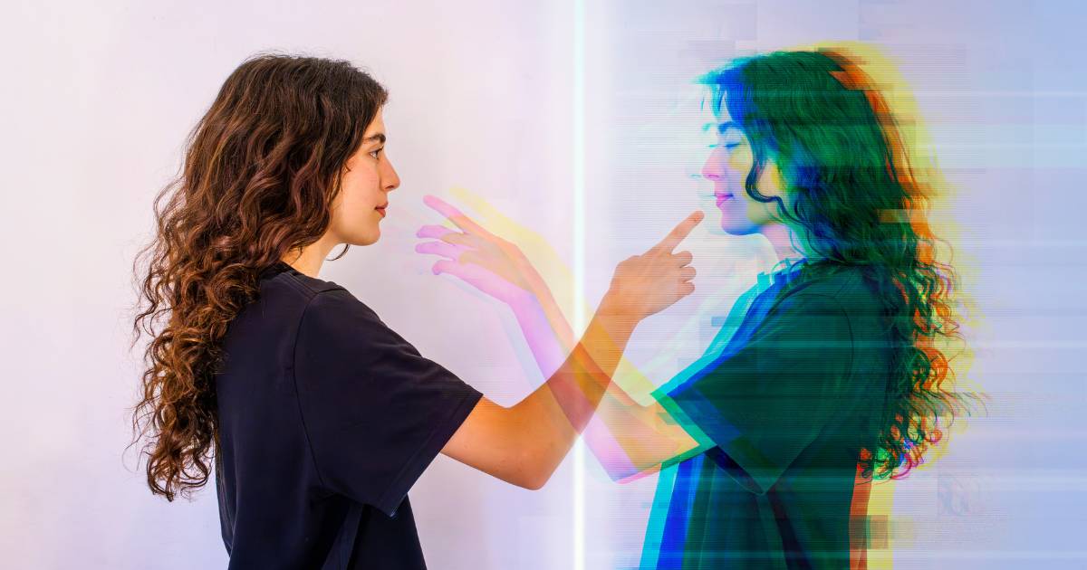 Young woman in front of her digital twin, reaching out to make contact