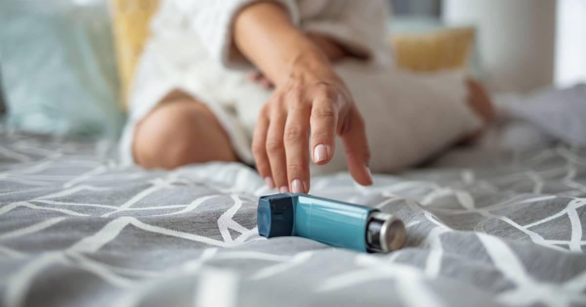 Woman reaching for her inhaler.