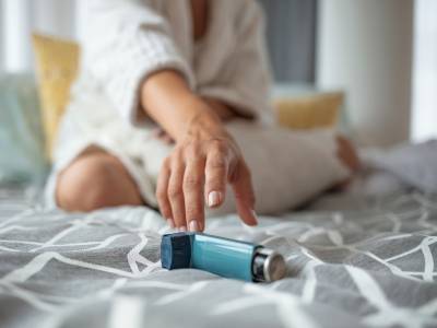 Woman reaching for her inhaler.