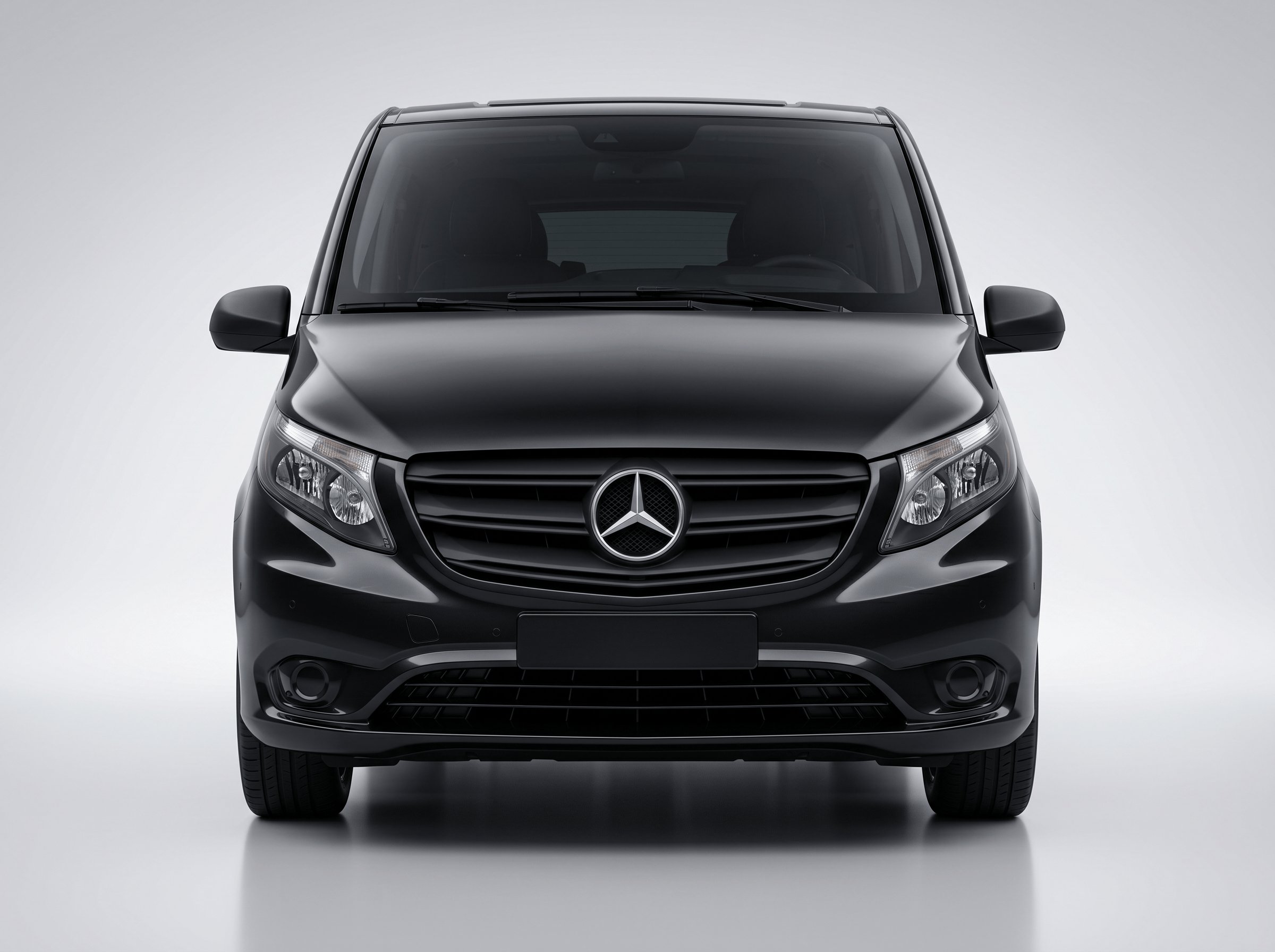 Front view of a black Mercedes-Benz luxury van on a light gray background.