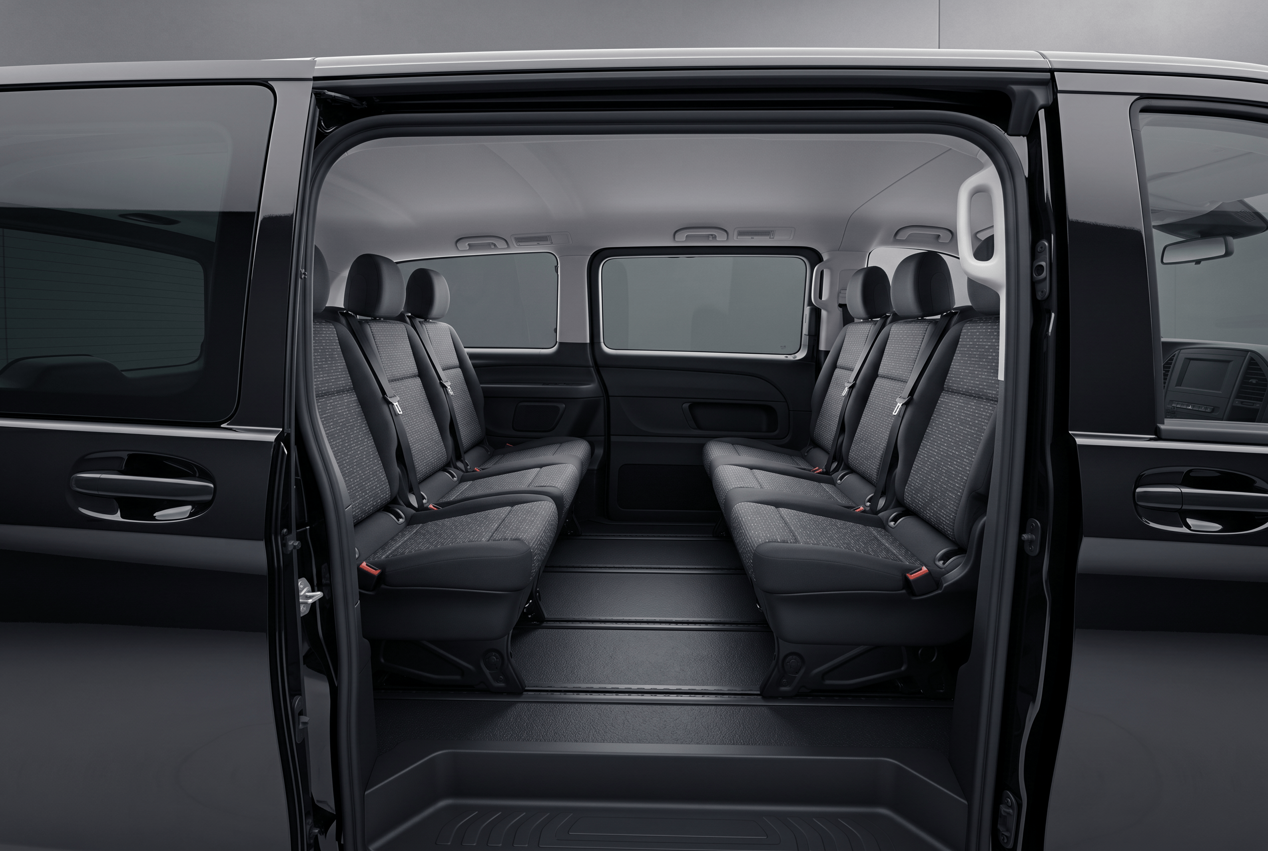Luxury vehicle interior with white and black seats, starry ceiling lights, and a central screen showing apps.