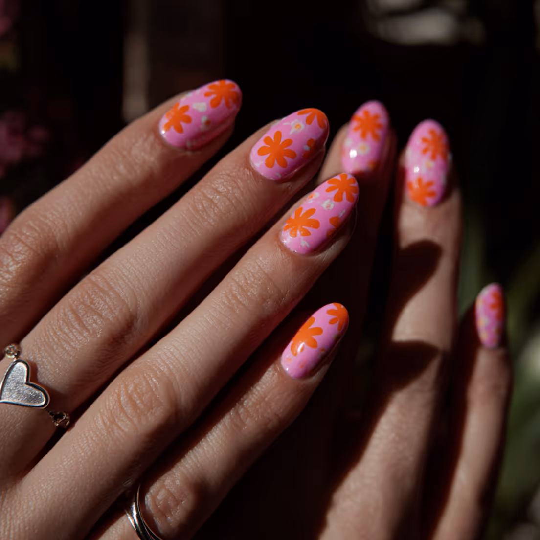 Pink nails on a manicured hand