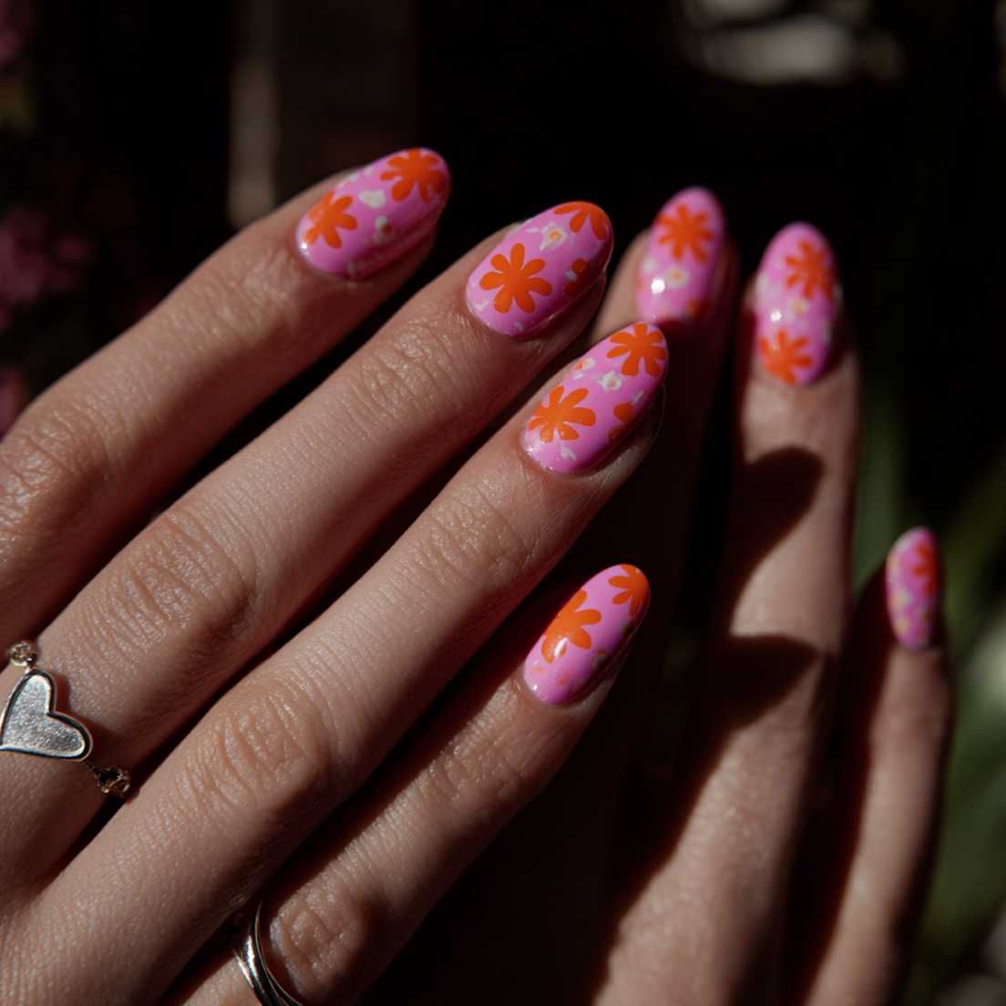 Pink nails on a manicured hand