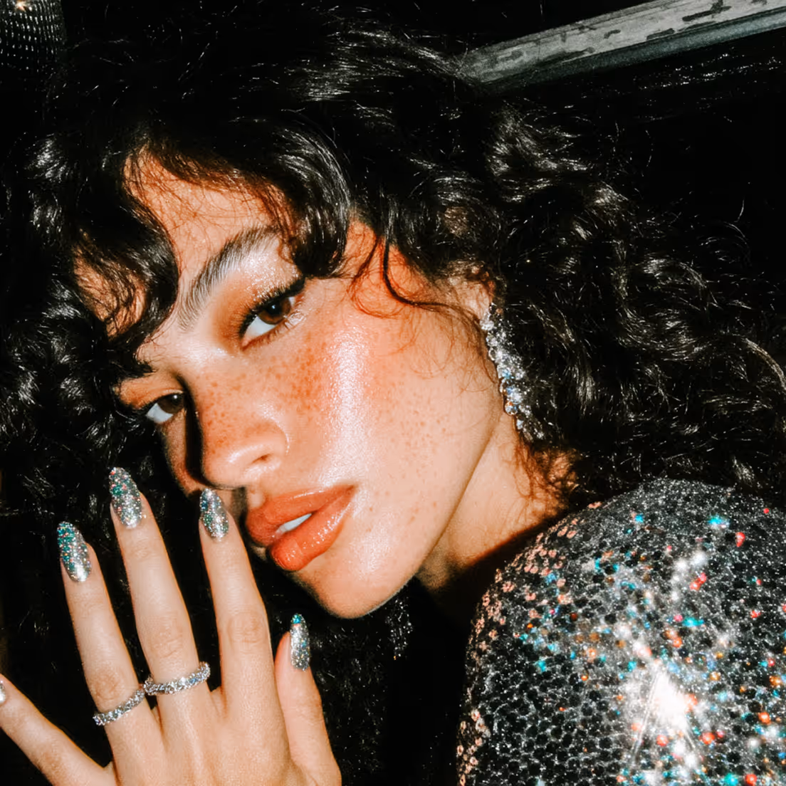 A glam shot of a girl with dark curly hair