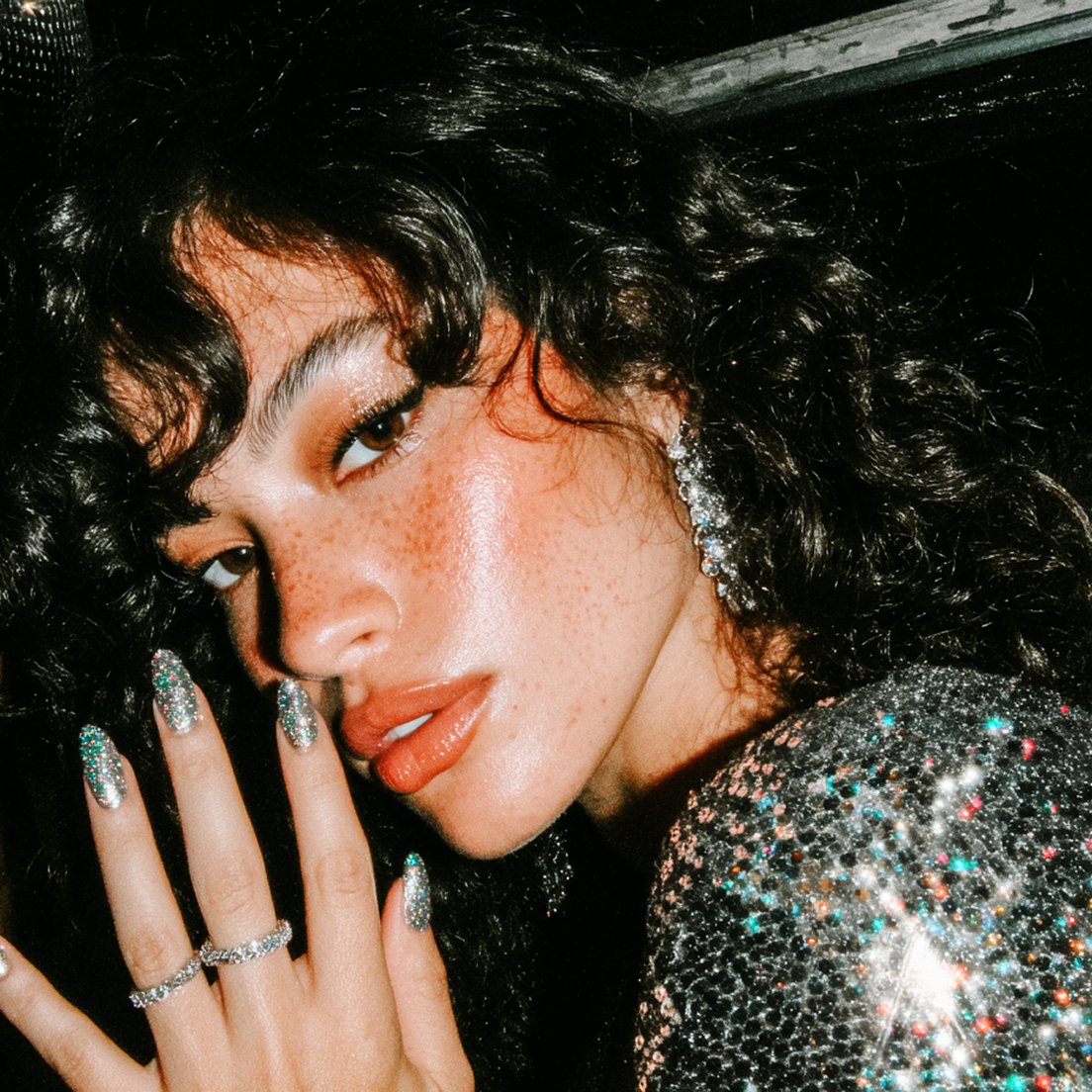 A glam shot of a girl with dark curly hair