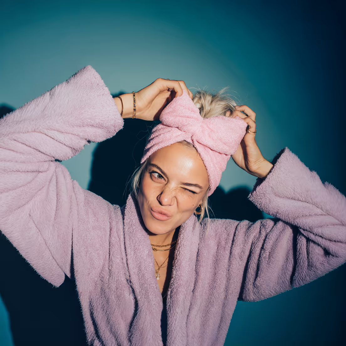 An image of a girl in a dressing down and hair towel