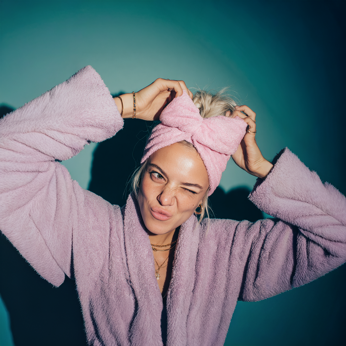 An image of a girl in a dressing down and hair towel