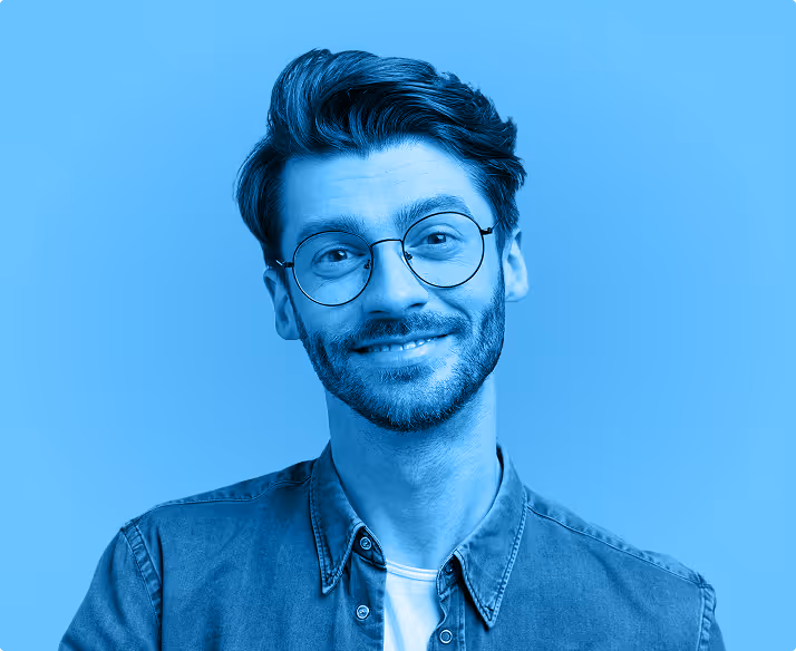 A young stylish man wearing glasses smiling on a blue background