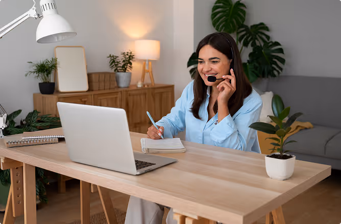 A freelancer working in headphones at the laptop