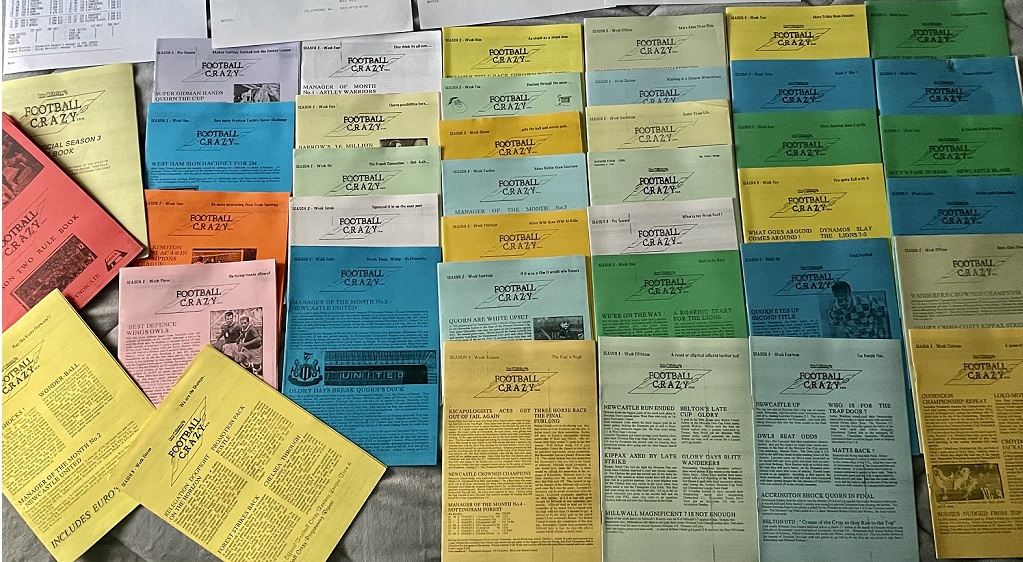 A collection of colorful Football Crazy booklets arranged in rows on a flat surface, featuring various football-related headlines and articles.