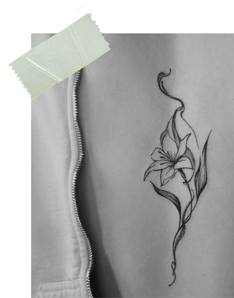 Black and white tattoo of a lily flower with long leaves and curving lines on a person's side near a partially unzipped jacket.