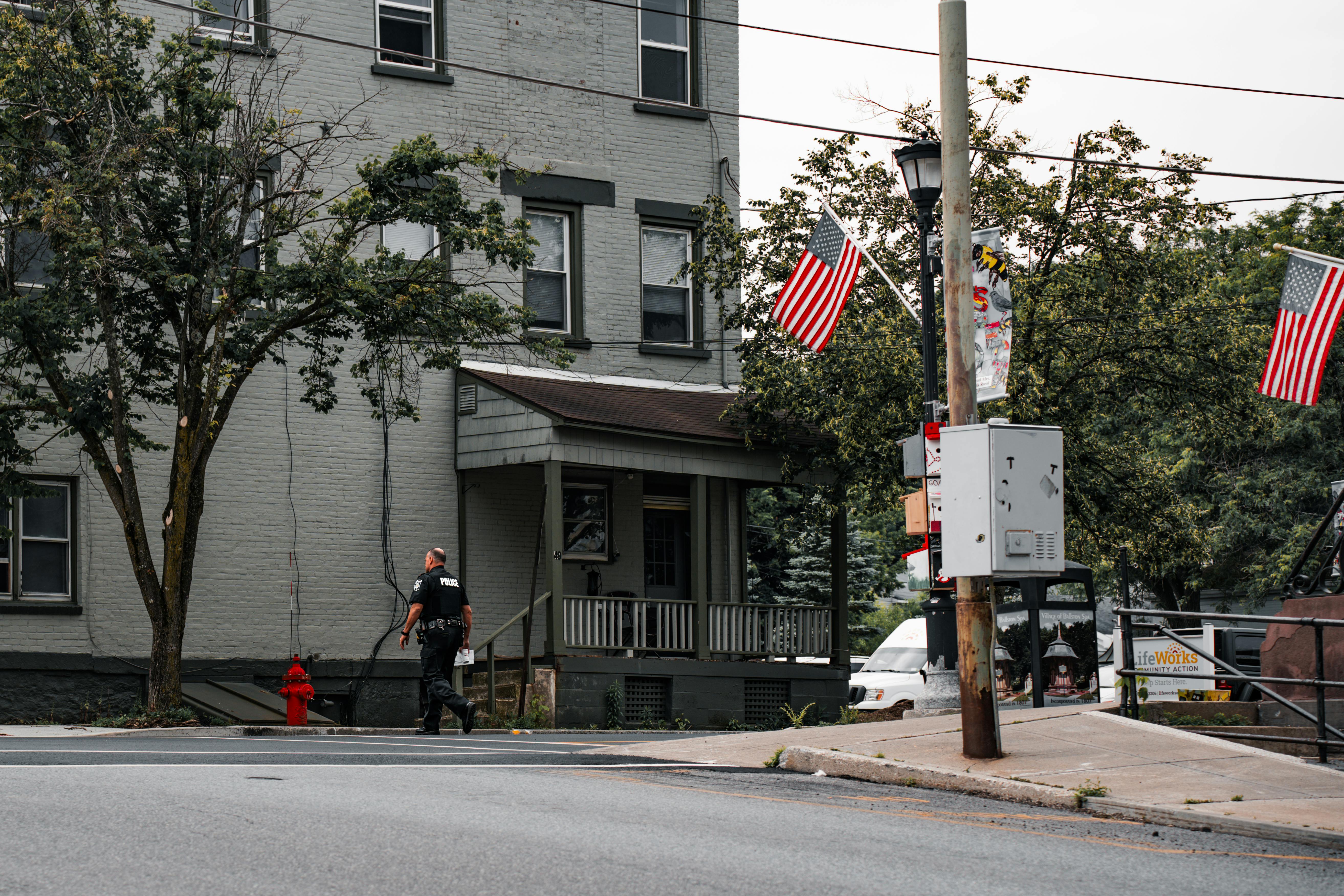 Officer walking a housing tier during an observation round, checking in on detainees