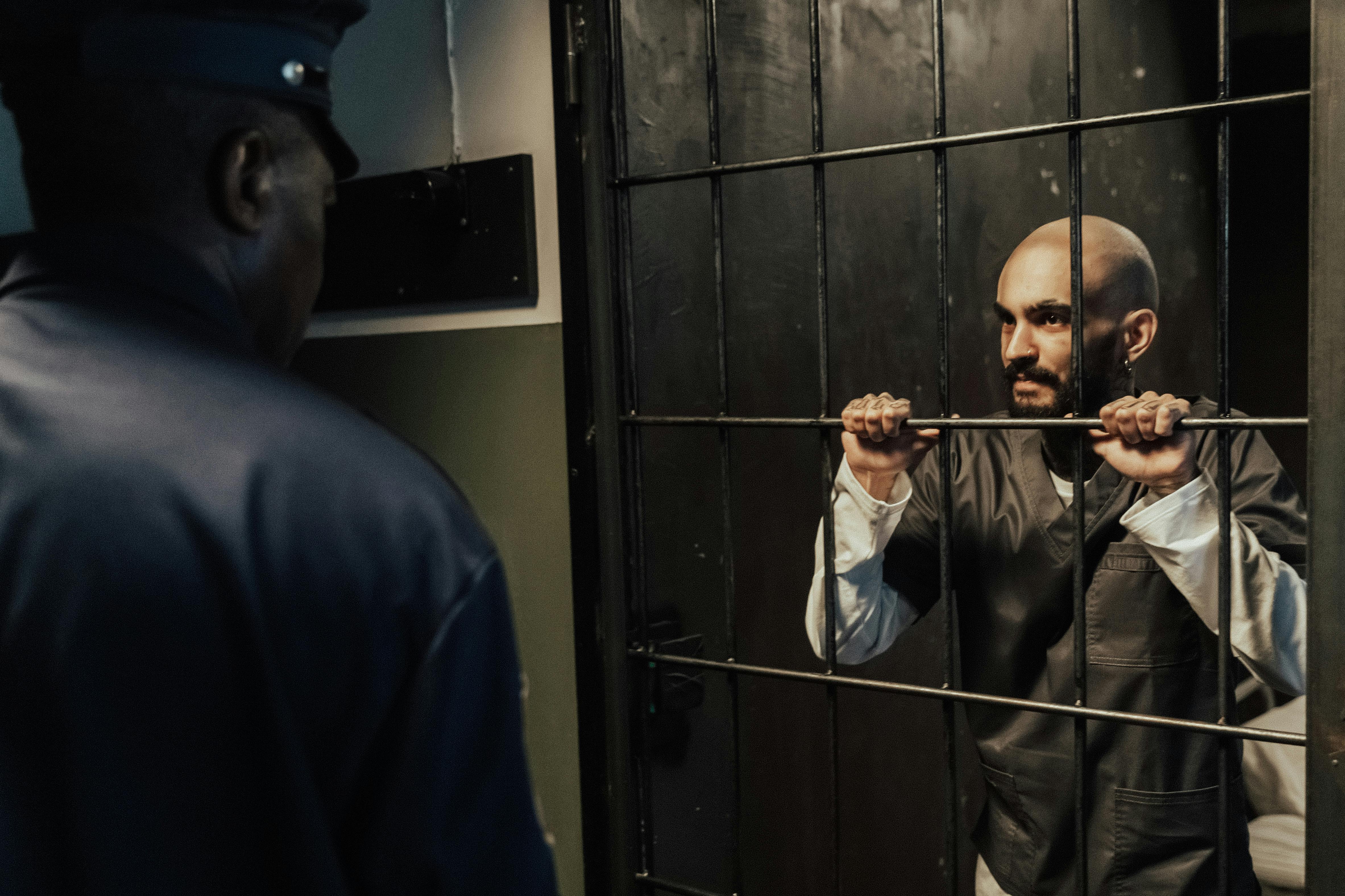 Officer at a housing unit station reviewing detainee status during a night round