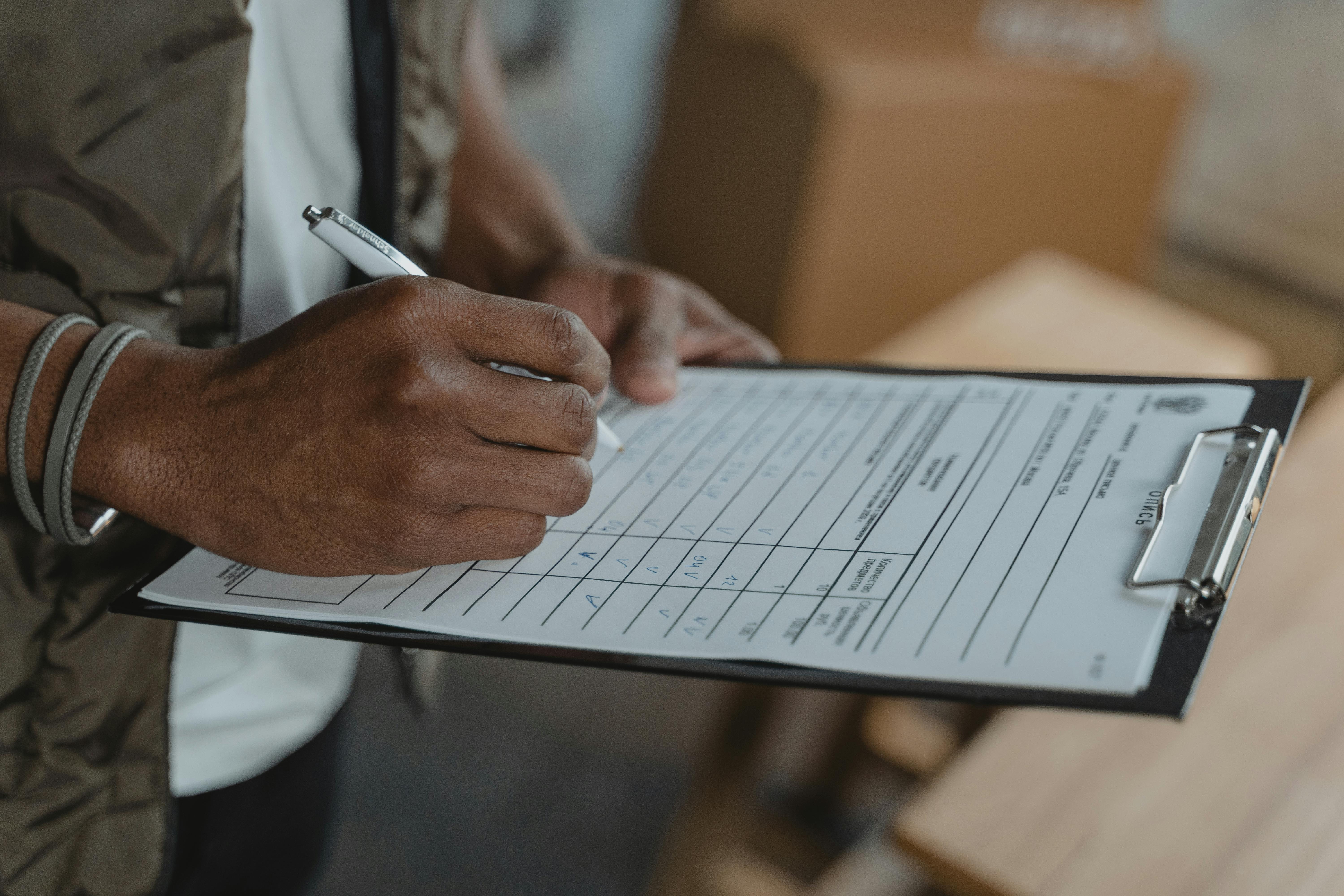 Officer writing in a housing unit log at a supervision station