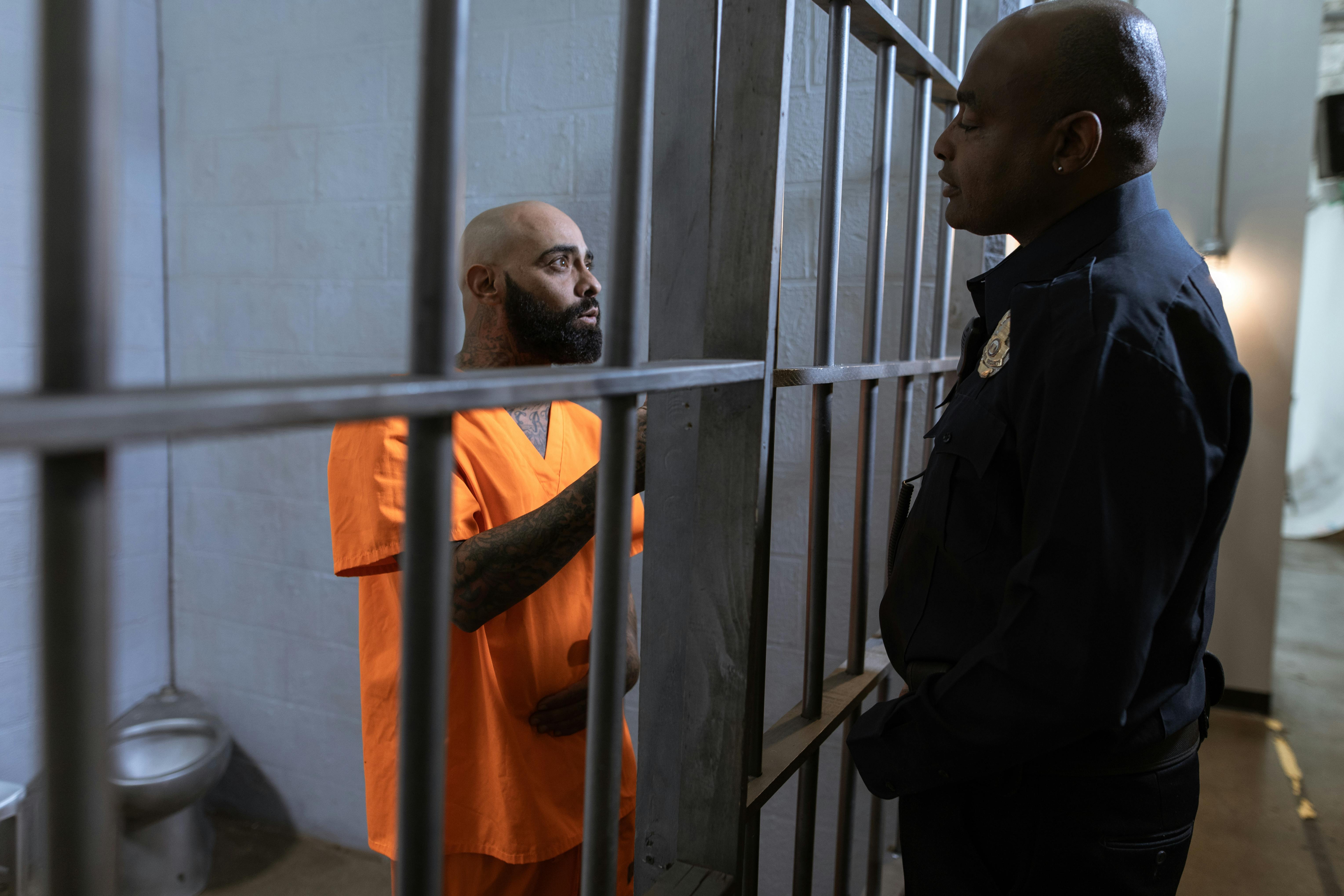 Officer conducting a welfare check at the door of a behavioral observation cell
