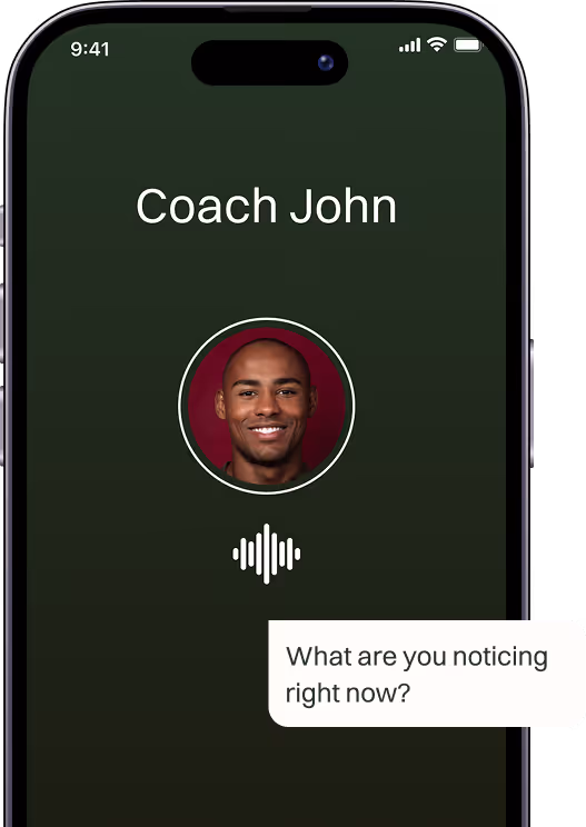 Smartphone screen showing a voice call with Coach John, including his smiling profile picture and a text bubble asking, 'What are you noticing right now?'