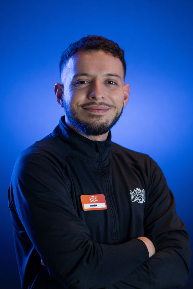 Studio headshot against a blue background