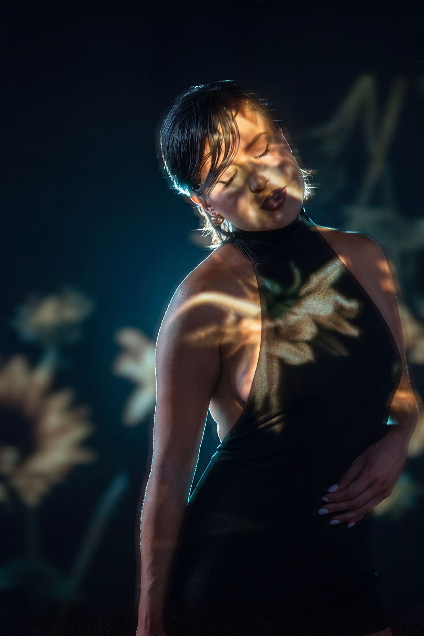 Ashleigh with warm floral projections and blue rim lighting
