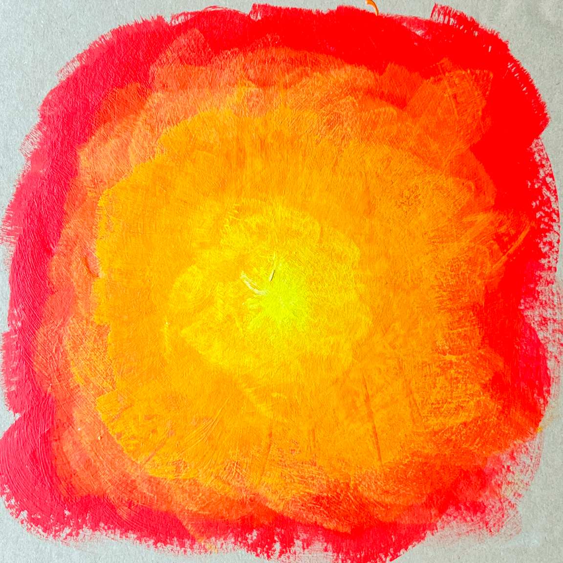 Abstract circular painting with a bright yellow center blending into orange and then red edges on a gray background.
