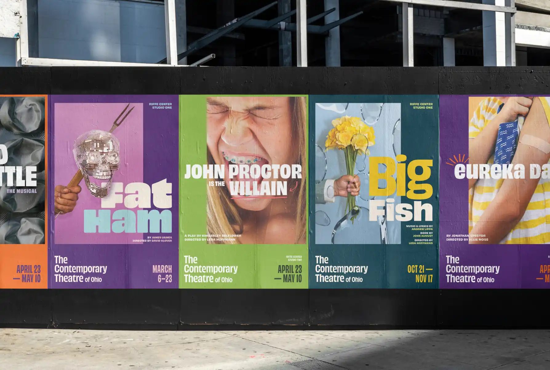Outdoor wall displaying colorful posters for plays at The Contemporary Theatre of Ohio including Fat Ham, John Proctor is the Villain, Big Fish, and Eureka Day.