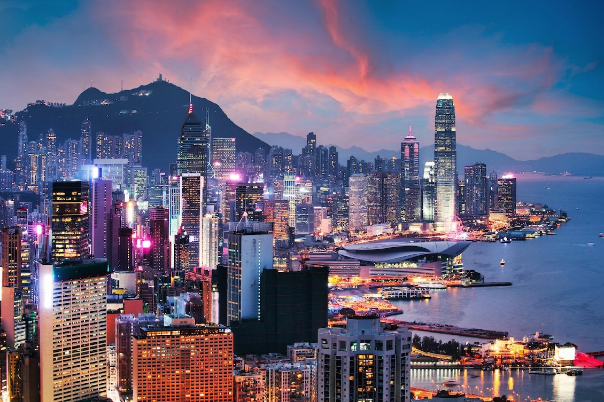 Panoramic view of the Victoria Harbour and Hong Kong skyline representing its status as a leading international financial center and gateway to Asia.