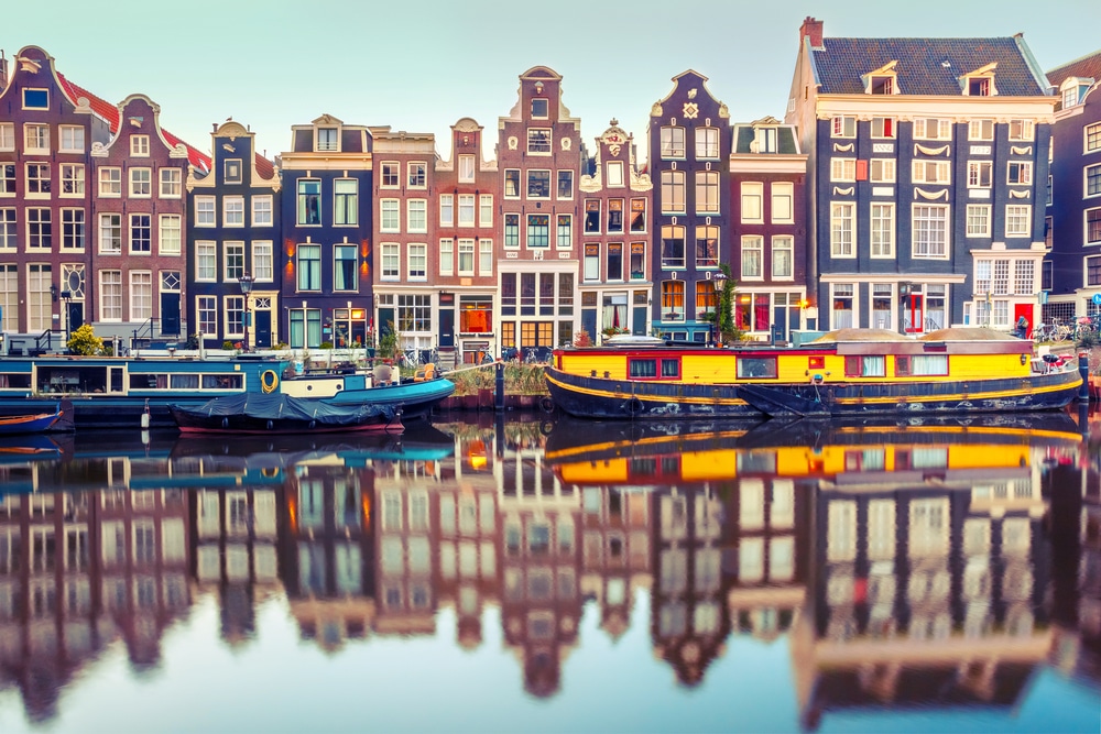 Panoramic view of the Amsterdam canals and historic architecture in the Netherlands representing its status as a premier global hub for international holding companies.