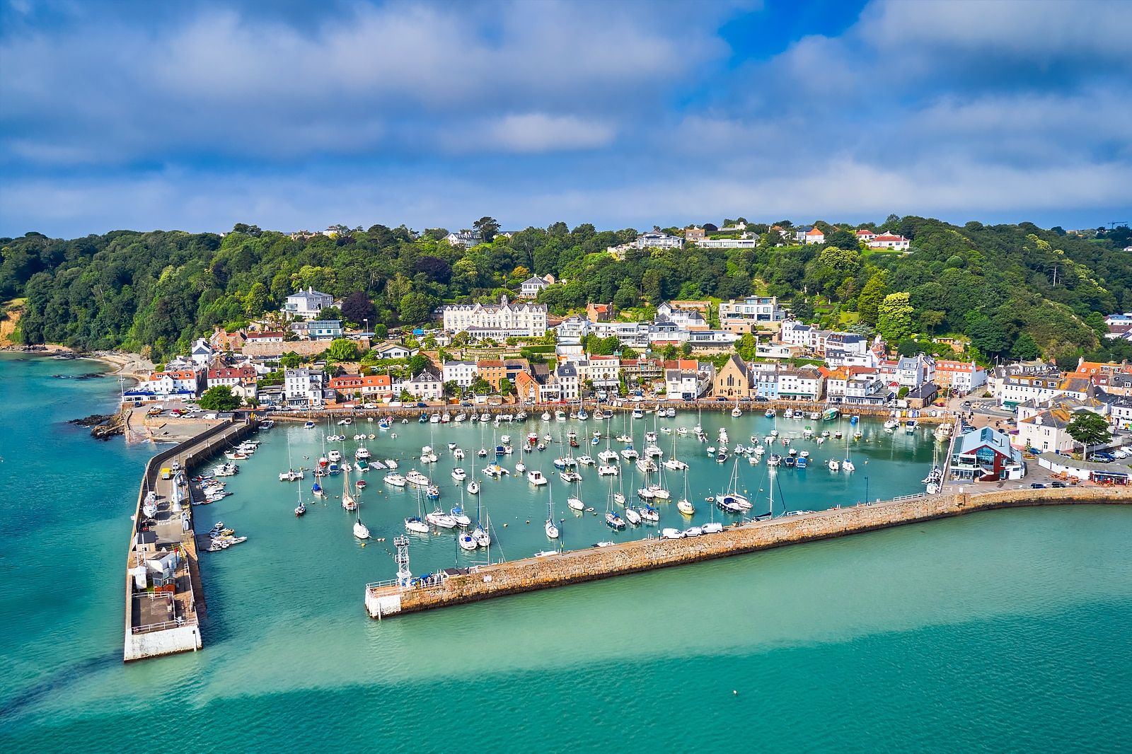 Panoramic view of the St. Helier harbor in Jersey representing its status as a premier global hub for private banking and wealth management.