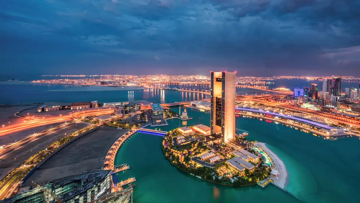 Aerial view of the Manama skyline in Bahrain representing its status as a cost-effective financial hub and gateway to the Saudi market.