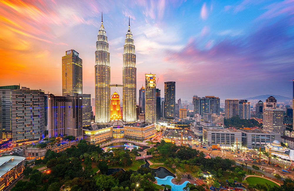Panoramic view of the Kuala Lumpur skyline featuring the Petronas Towers representing Malaysia as a strategic ASEAN business hub.