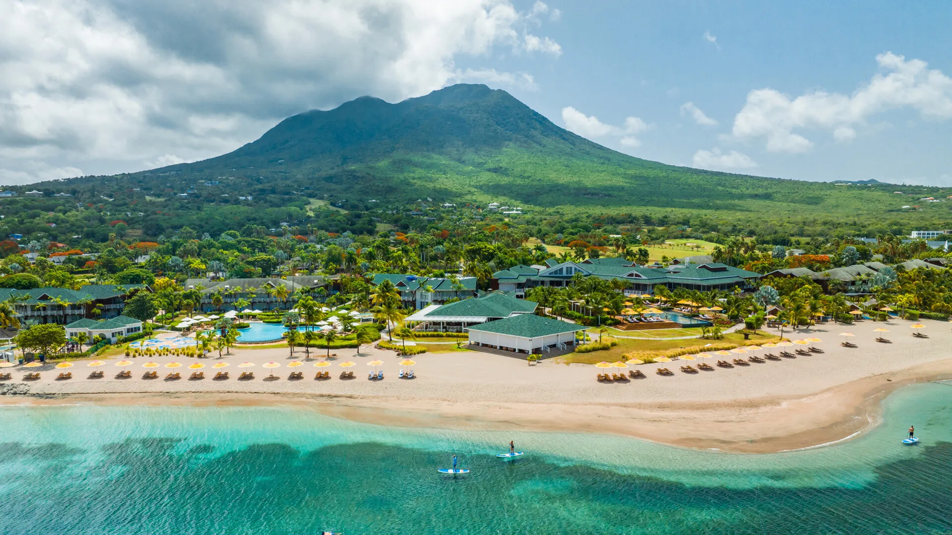 Panoramic view of the Nevis Peak and coastline in St Kitts & Nevis representing its status as a premier destination for global citizenship and luxury investment.