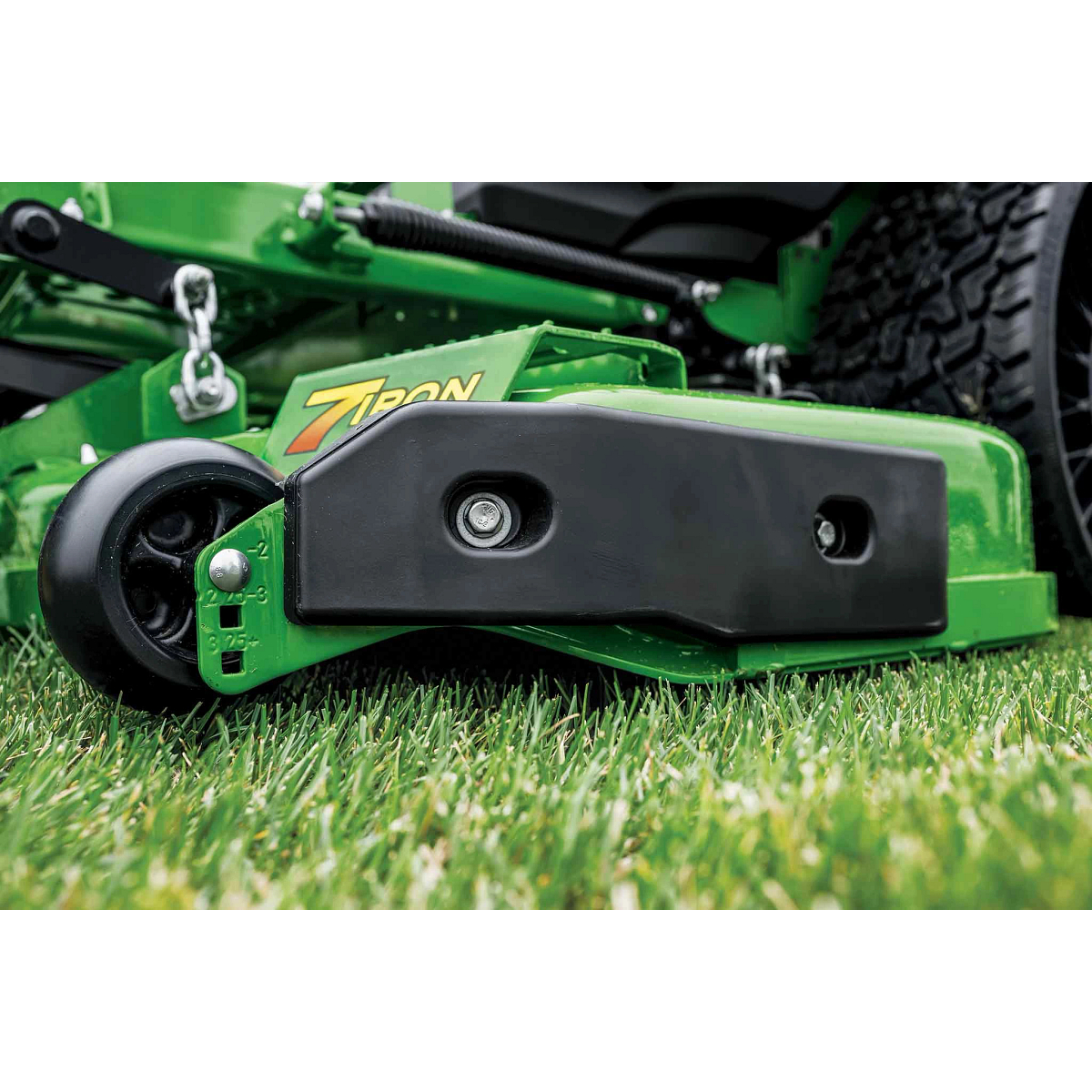 A close-up side shot of a green 7Iron deck for a zero-turn mower.