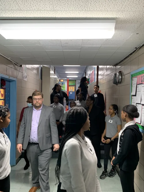 Group of students and a teacher walking