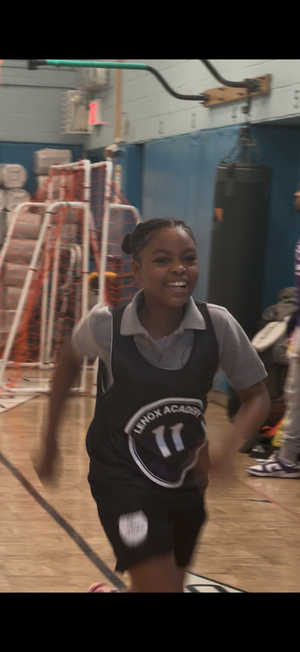 Youth basketball team posing in a gymnasium 