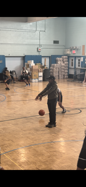 Boys playing basketball in an indoor gymnasium