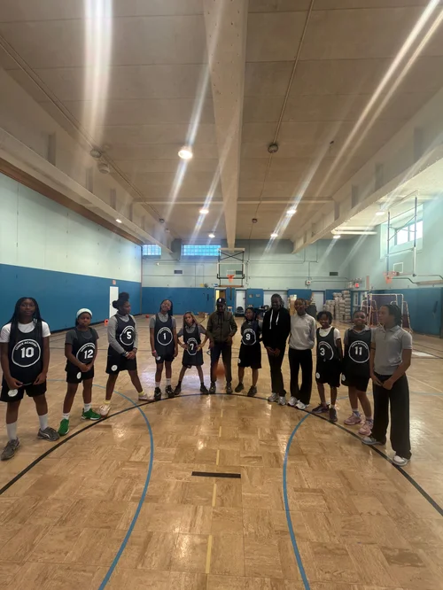 Youth basketball team wearing black jerseys 