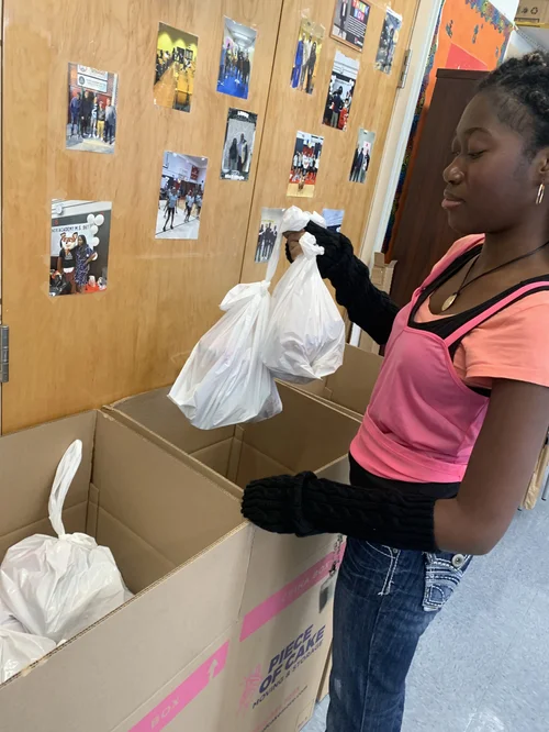 Young person wearing black gloves