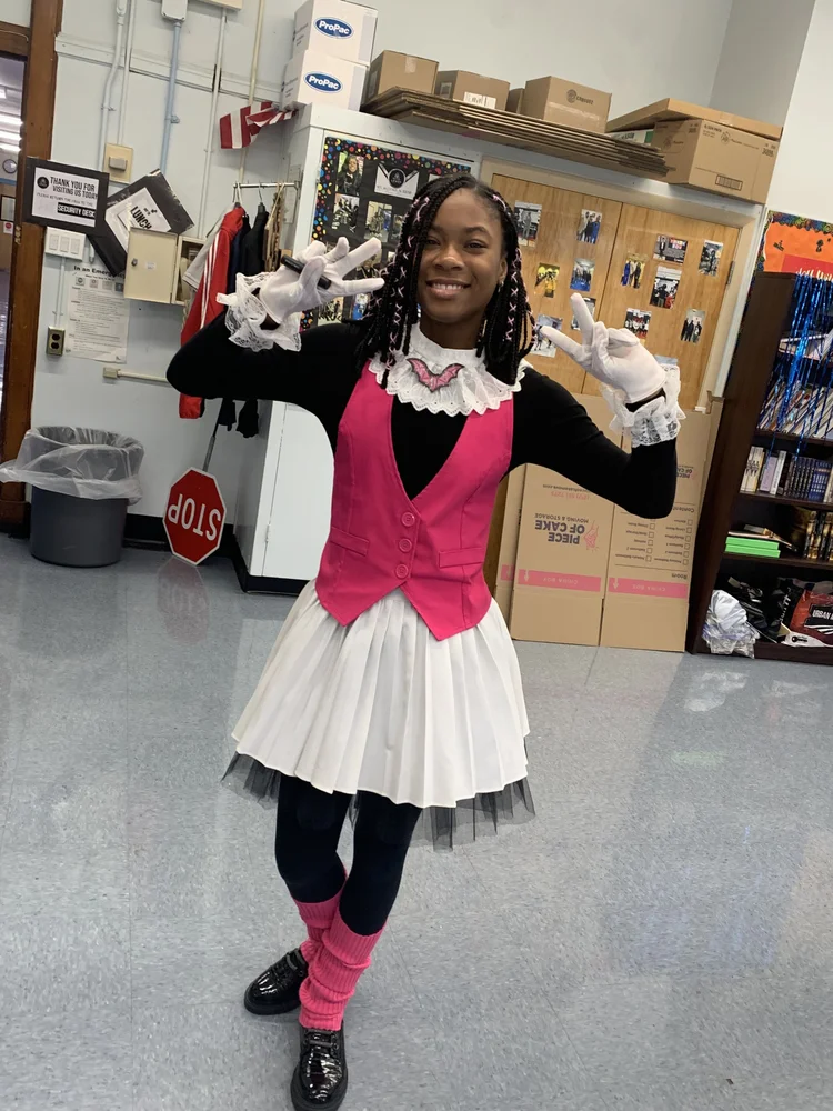 Smiling girl in a pink vest, white skirt